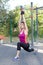 Gorgeous slim young woman practices yoga at outdoor sportsground. Hero asana. Calmness and relax, stretching. Real woman morning t