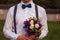 Gorgeous smiling groom. andsome groom at wedding tuxedo waiting for bride.Elegant man in white shirt and bow-tie.