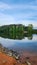 a gorgeous spring landscape at Proctor Landing Park at sunset with rippling water surrounded by lush green trees and plants