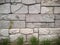 Gorgeous Stone Wall With Perfectly Fit Pieces of Differemt Sizes With Some Greass Growing