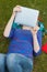 Gorgeous student lying on grass using tablet