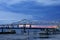 a gorgeous summer landscape along the Mississippi River with the Crescent City Connection bridge over the water with blue sky