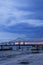 a gorgeous summer landscape along the Mississippi River with the Crescent City Connection bridge over the water with blue sky