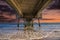 A gorgeous summer landscape at the beach under the Belmont Veterans Memorial Pier with blue ocean water and waves