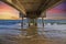 A gorgeous summer landscape at the beach under the Belmont Veterans Memorial Pier with blue ocean water and waves