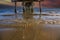 A gorgeous summer landscape at the beach under the Belmont Veterans Memorial Pier with blue ocean water and waves