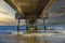 A gorgeous summer landscape at the beach under the Belmont Veterans Memorial Pier with blue ocean water and waves