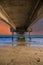 A gorgeous summer landscape at the beach under the Belmont Veterans Memorial Pier with blue ocean water and waves