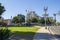 A gorgeous summer landscape at Father Serra Park with lush green palm trees, grass and plants and people relaxing