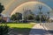 A gorgeous summer landscape at Father Serra Park with lush green palm trees, grass and plants and people relaxing with blue sky,