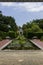 a gorgeous summer landscape at New Orleans Botanical Garden with a pond covered in lily pads and colorful water lilies, lush green