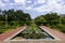 a gorgeous summer landscape at New Orleans Botanical Garden with a pond covered in lily pads and colorful water lilies, lush green