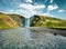 Gorgeous summer view of Skogafoss Waterfall on Skoga river. Great summer scene of Iceland, Europe. Beauty of nature concept