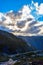 Gorgeous sunbeams pass through the clouds illuminating the mountain range where the path to Kjeragbolten lies. Norway