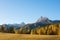 Gorgeous sunny view of Dolomite Alps with yellow larch trees. Colorful autumn panorama view landscape.