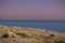 Gorgeous sunset at a beach in Alexandria, Egypt with a purple-pink sky over a quiet, dark sea