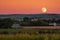 gorgeous sunset, with the harvest moon rising in the background