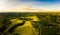 Gorgeous sunset over beautiful green vineyards. Aerial panorama sunset over Austrian grape hills in spring