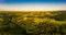 Gorgeous sunset over beautiful green vineyards. Aerial panorama sunset over Austrian grape hills in spring