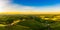 Gorgeous sunset over beautiful green vineyards. Aerial panorama sunset over Austrian grape hills in spring