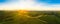 Gorgeous sunset over beautiful green vineyards. Aerial panorama sunset over Austrian grape hills in spring