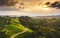 Gorgeous sunset over beautiful green vineyards. Aerial shoot of grape hills in summer