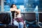 Gorgeous traveler girl sit on a chair at airport. Beautiful woman is waiting airline calling. The airline postpone for takeoff. I