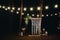 Gorgeous unusual boho chic wedding arch for wedding ceremony outdoors at night