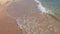Gorgeous view of foamy waves on sand coast  Mediterranean sea rolling on coast of beach.