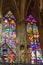 Gorgeous view of intricate stained glass windows with colorful religious illustrations in a church
