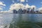 Gorgeous view of Manhattan from river Hudson side. Skyscrapers on blue sky with white clouds background. New York.