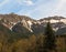 Gorgeous view of a mountain melting snow in spring lone tree and forest