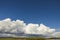 Gorgeous view of natural landscape on a summer day. Forest, blue sky and clouds converging on the horizon.