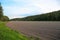 Gorgeous view of plowed field ready for sowing of winter crops. Agriculture concept. Sweden