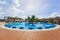 Gorgeous view of a round swimming pool at Iberostar Playa Pilar resort with people relaxing and enjoying their leisure time on sun