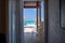 Gorgeous view on sandy beach and Atlantic Ocean from a room. Sun beds and umbrellas on turquoise water and blue sky background.