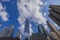 Gorgeous view of skyscrapers of Manhattan against blue sky with white clouds.