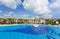 Gorgeous view of swimming pool at Iberostar Playa Pilar resort with people relaxing and enjoying their vacation time on sunny