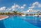 Gorgeous view of swimming pool at Iberostar Playa Pilar resort with people relaxing and enjoying their vacation time on sunny beau