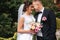 Gorgeous wedding couple walking on the back yard of couples house. Green background