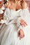 A gorgeous wedding dress and hands. Neckline, no face. wedding.