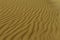 Gorgeous wind markings on the sand close up natural pure dunes at Sampieri beach in Sicily in a summer sunny windy day