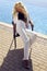 Gorgeous woman with blond hair in luxurious white suit