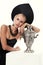 Gorgeous woman with blond hair in russian national hat with samovar