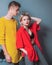 Gorgeous woman with in red shirt posing with handsome brunette man in yellow sweater. Fashion portrait beautiful sexy