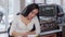 Gorgeous woman smiling to the camera, signing papers after buying new car