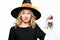 Gorgeous woman in witch costume holding Halloween skeleton decoration with disgust. Halloween concept.