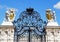 Gorgeous wrought iron gate and pair of lion sculptures against vivid blue sky, Vienna