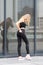 Gorgeous young blonde wearing black pants and top posing outdoor