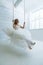 Gorgeous young bride on swing in studio